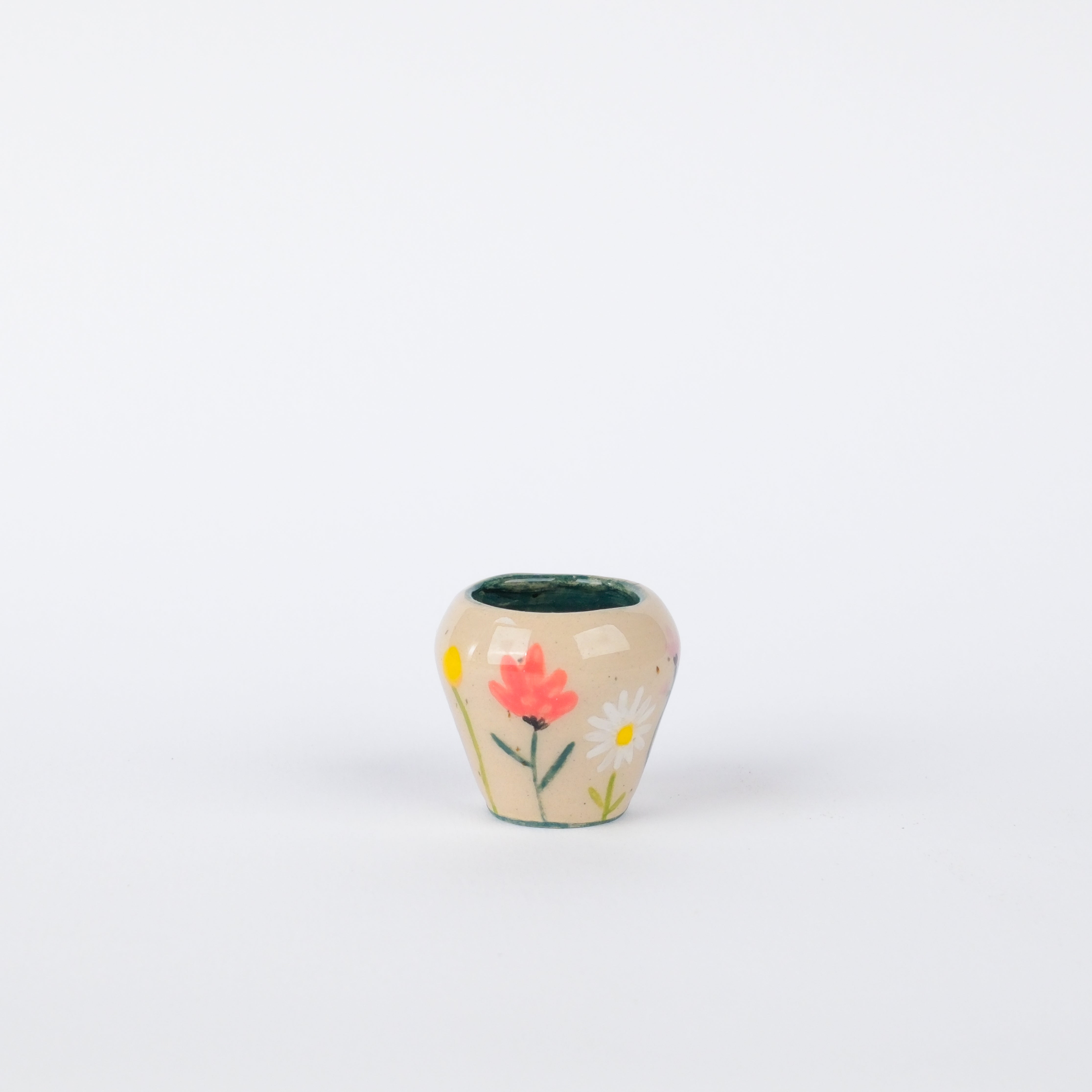 Hand-painted 29mm stoneware tiny pot with colorful floral motifs on a speckled cream glaze and teal interior.