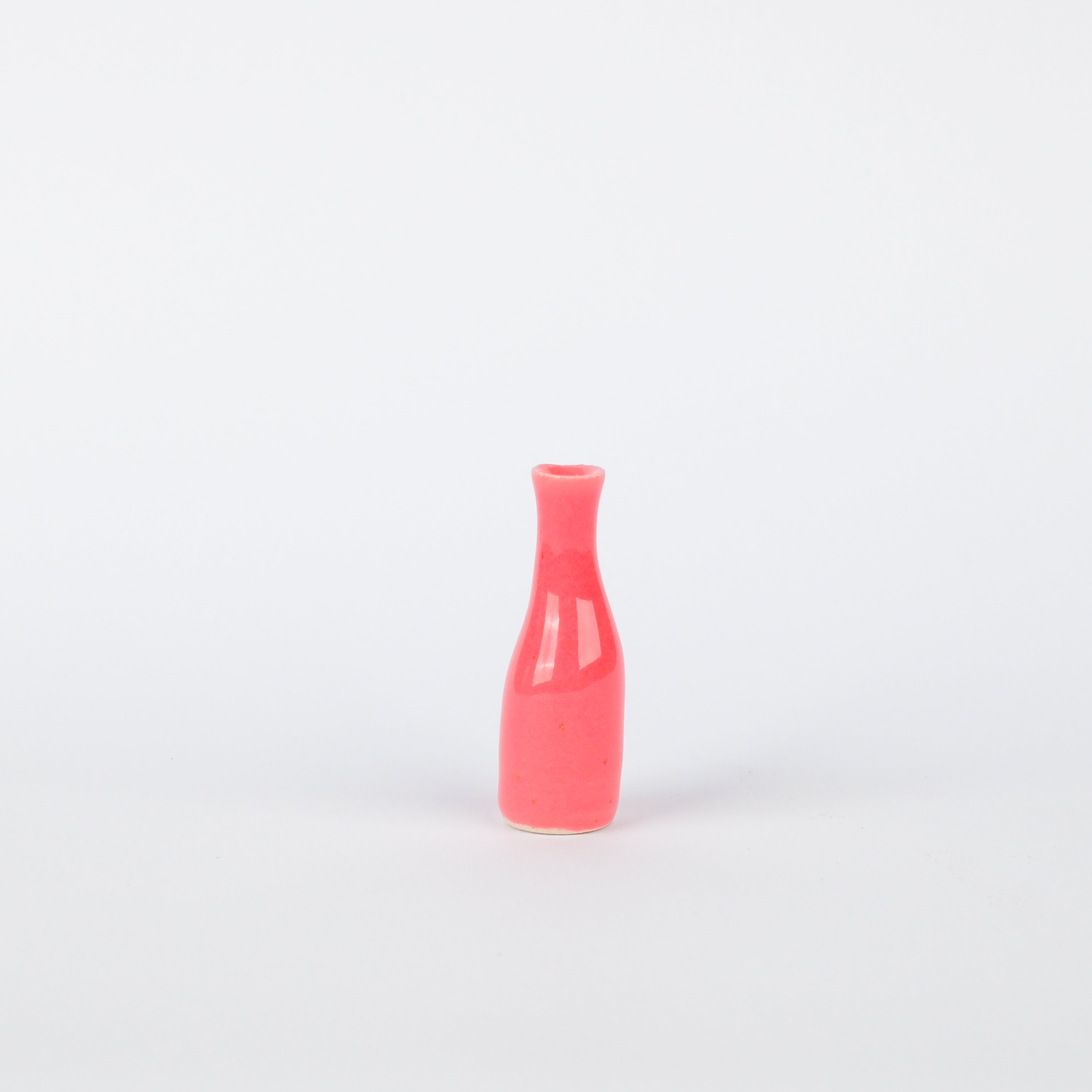 Hand-painted 45mm pink stoneware vase with a slender, organic bottle shape on a white background.