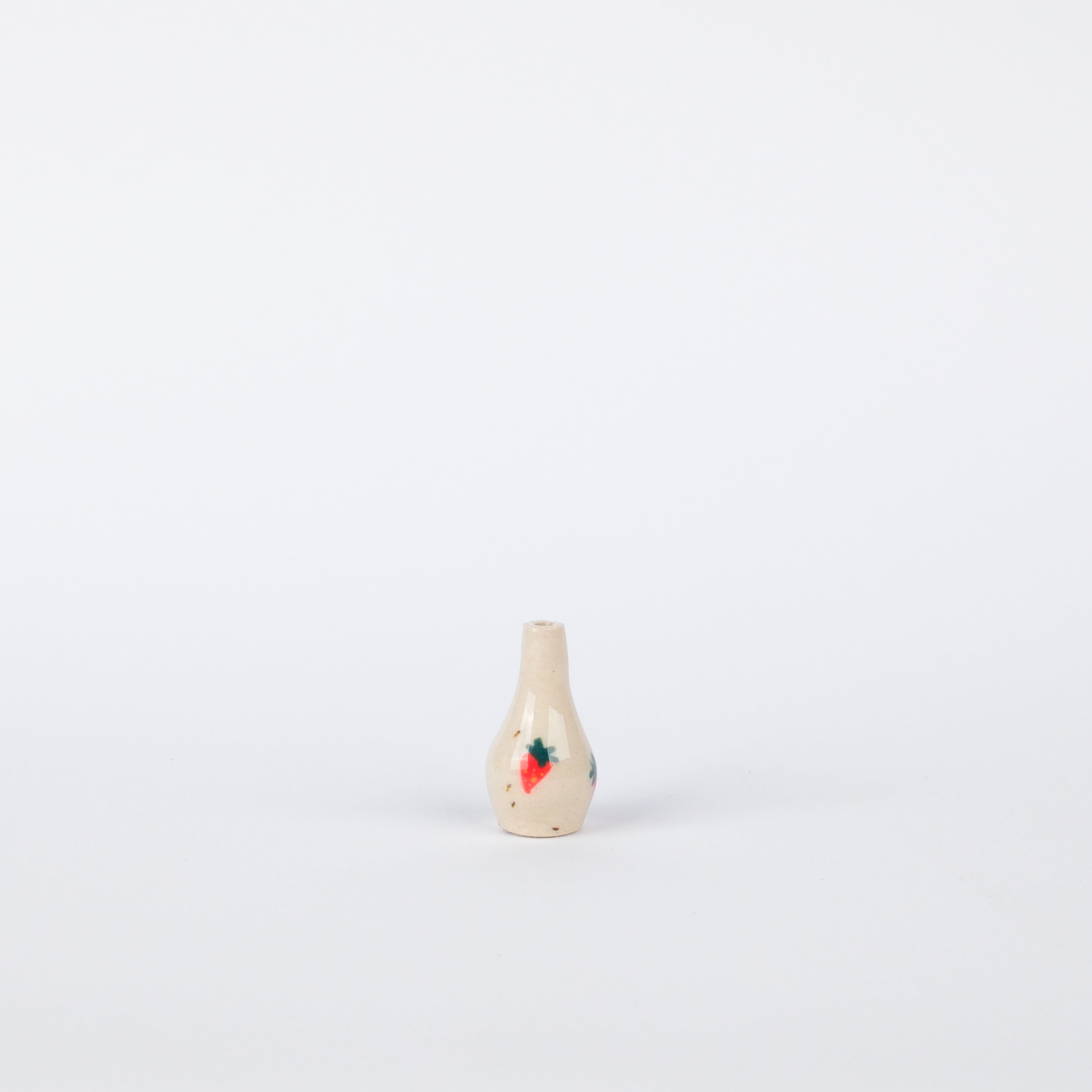 Small, speckled stoneware vase with hand-painted strawberry design, 26mm tall, on a white background.