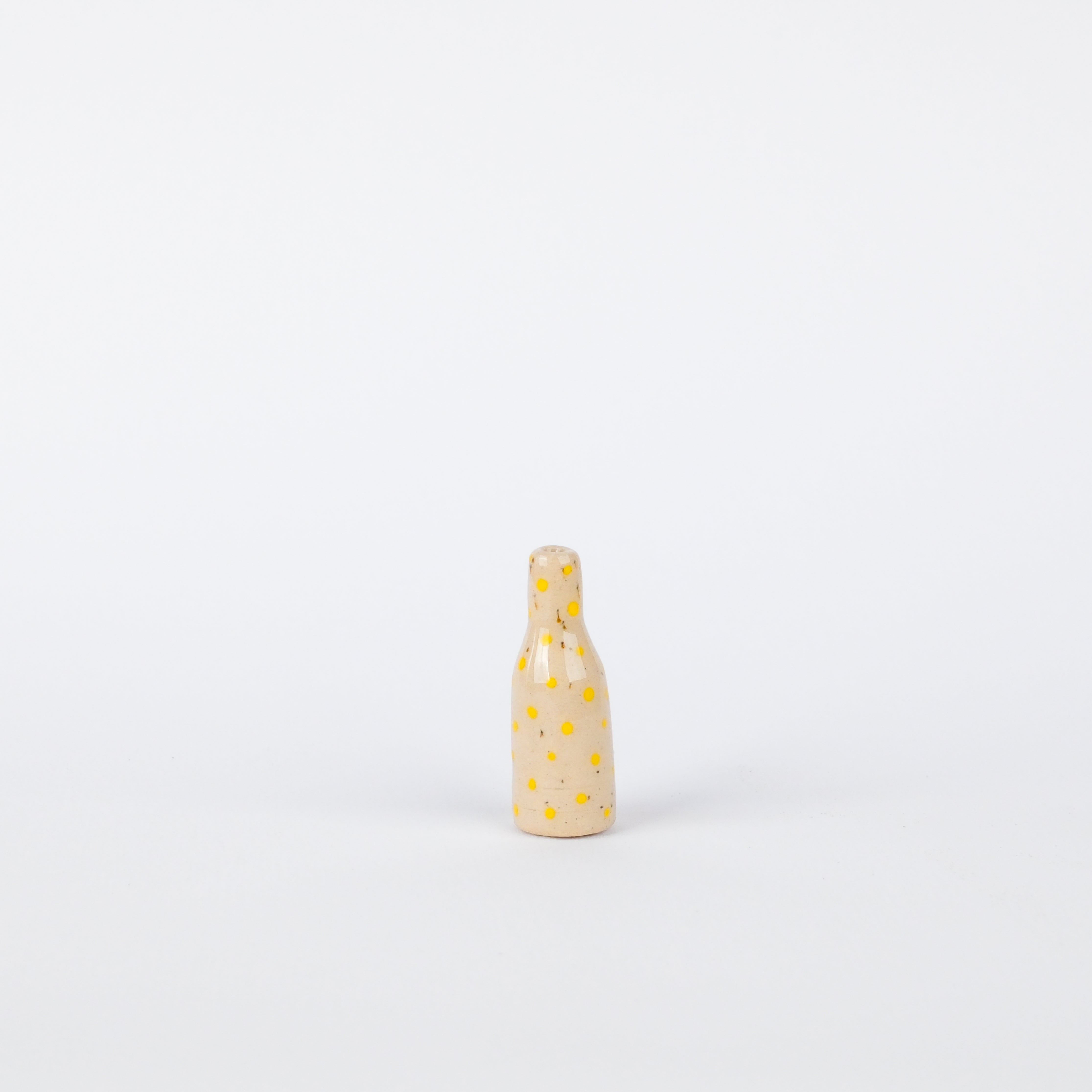 Handcrafted 35mm speckled stoneware vase in cream with small, hand-painted yellow polka dots on a white background.